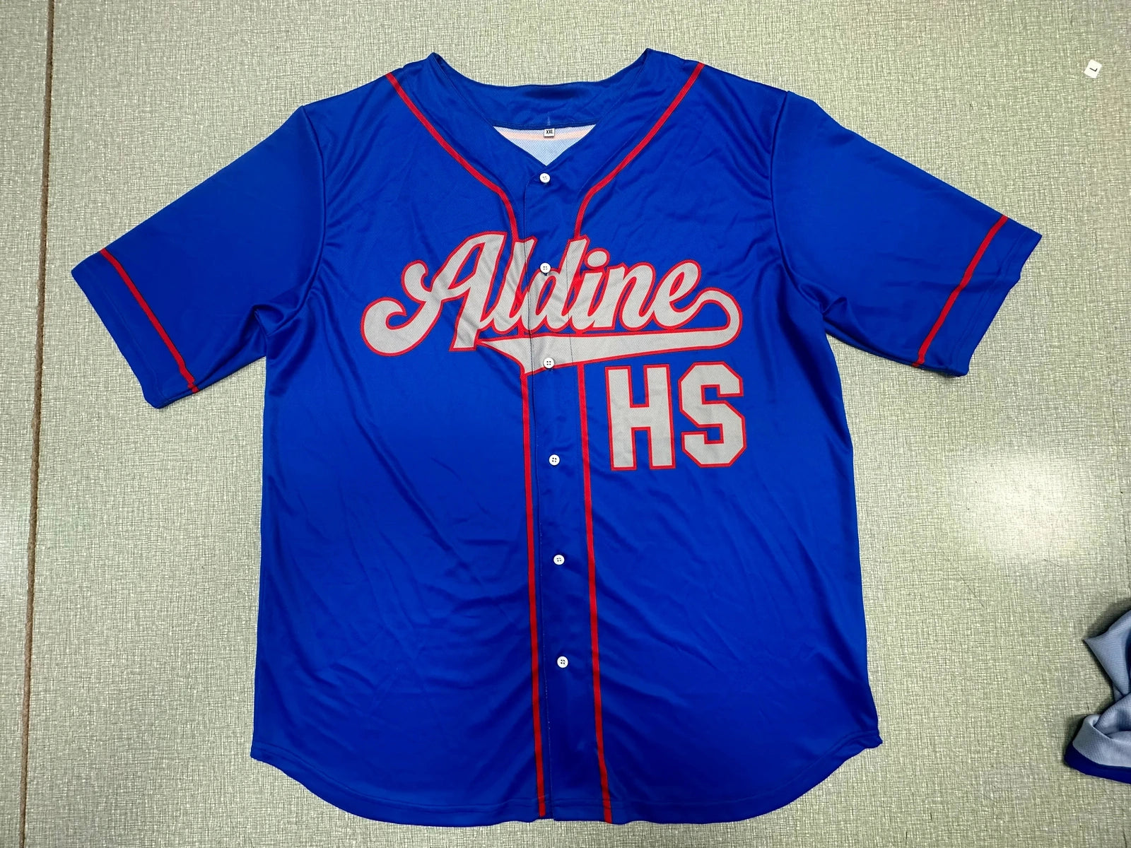 Blue button-down baseball jersey with sample school lettering