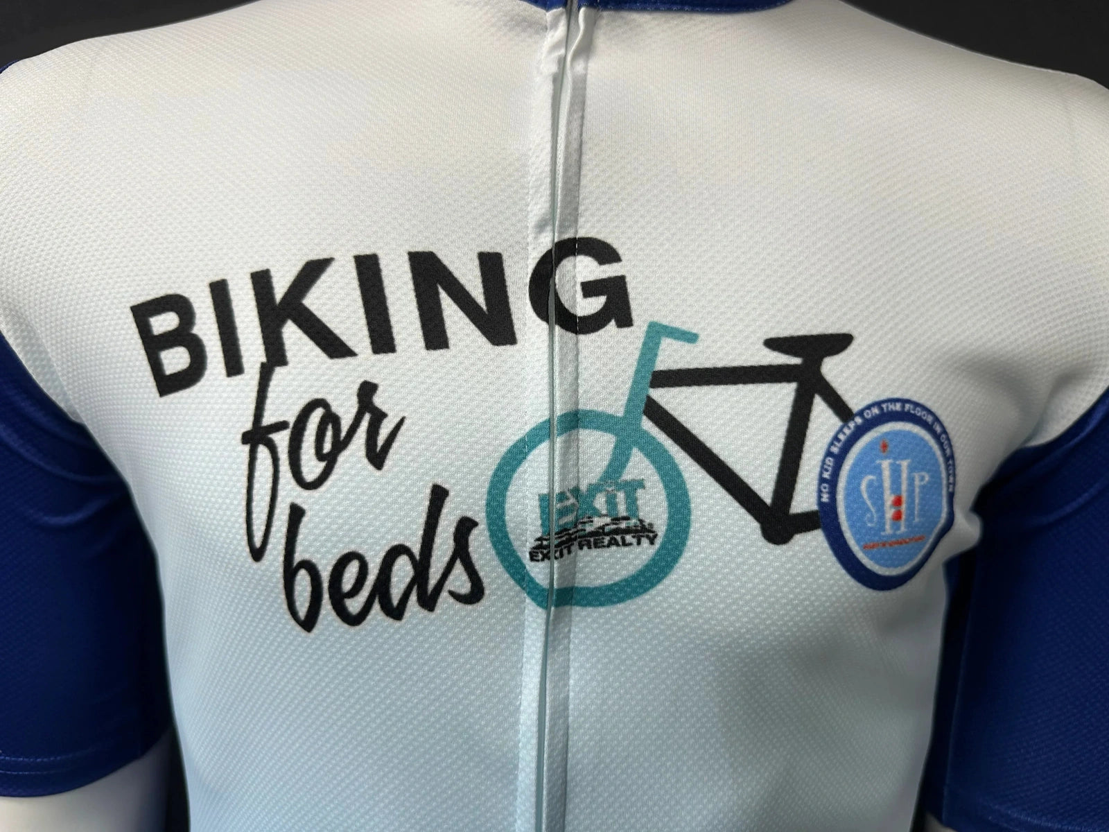 Close-up of printed artwork on a white and blue cycling jersey